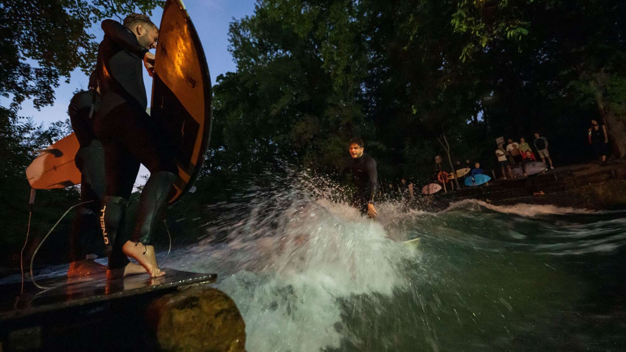 Surfer bei Nacht auf dem Eisbach