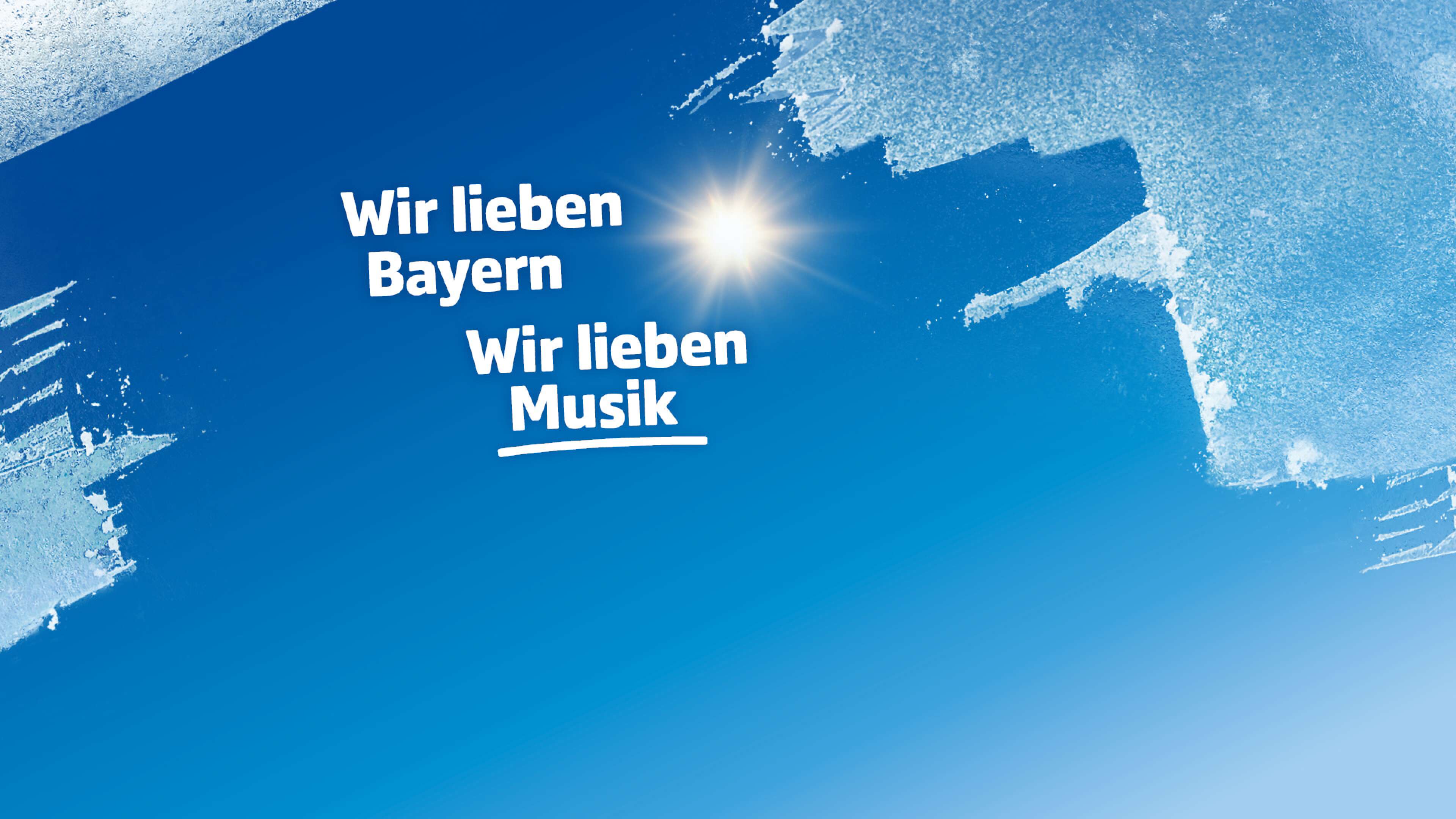 Blauer Himmel mit strahlender Sonne, am Bildrand Eis wie bei einer freigekratzten Autoscheibe, dazu der Text: Wir lieben Bayern, wir lieben Musik