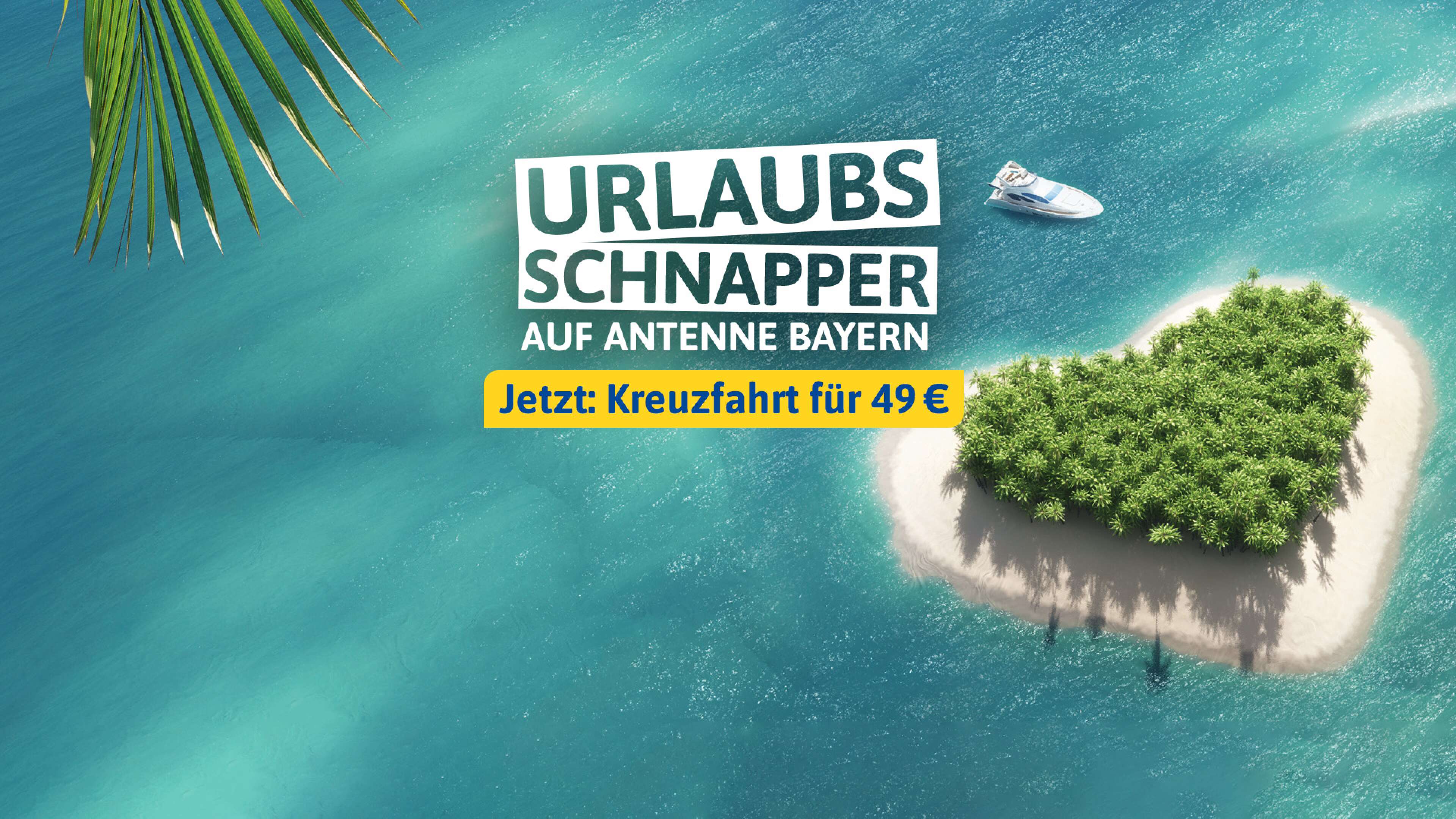 Eine Insel in der Südsee in Herzform umrahmt von türkisblauem Wasser, dazu der Text: Urlaubsschnapper auf ANTENNE BAYERN - jetzt: Kreuzfahrt für 49 Euro