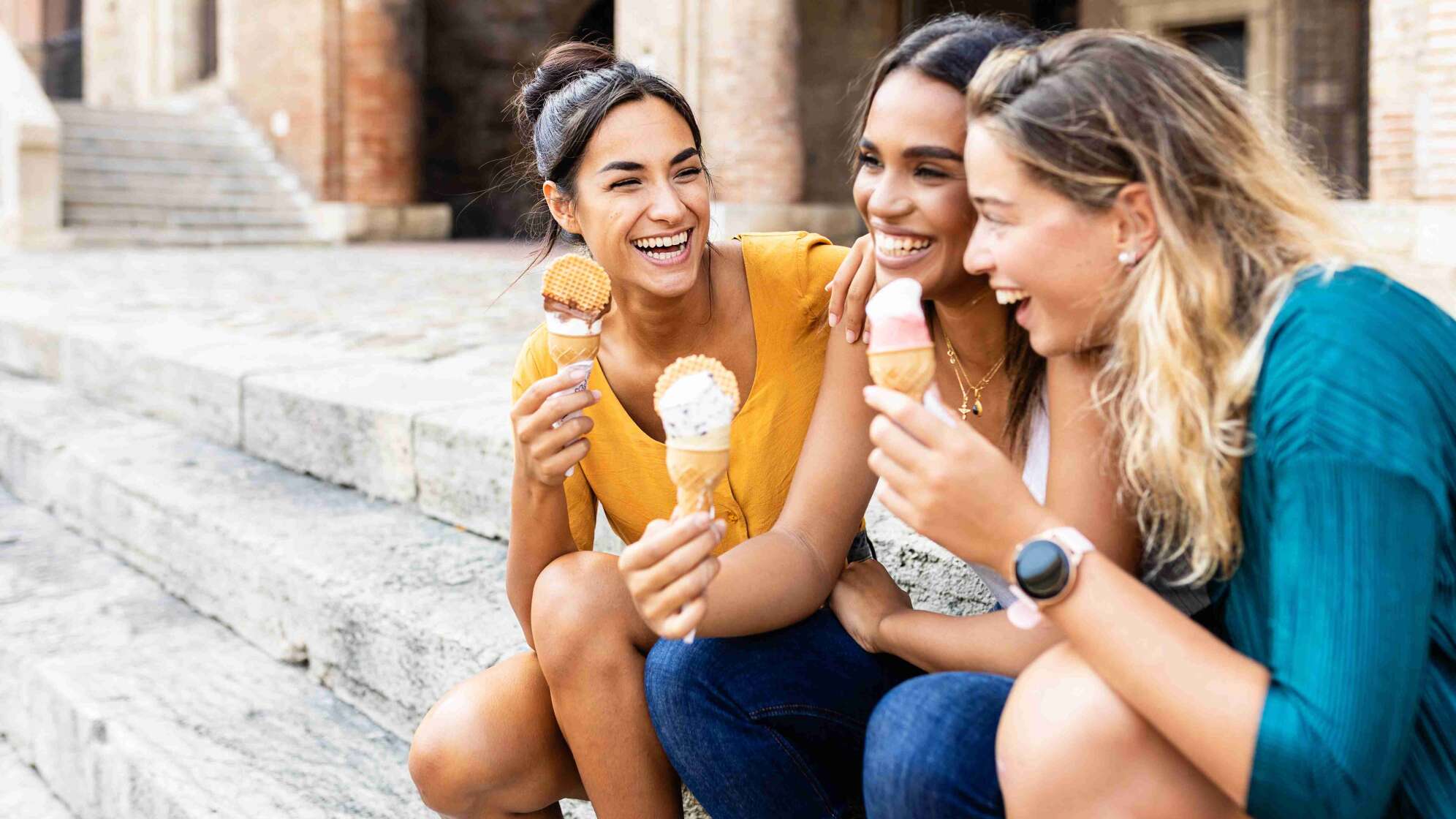 Frauen essen Eis auf der Treppe