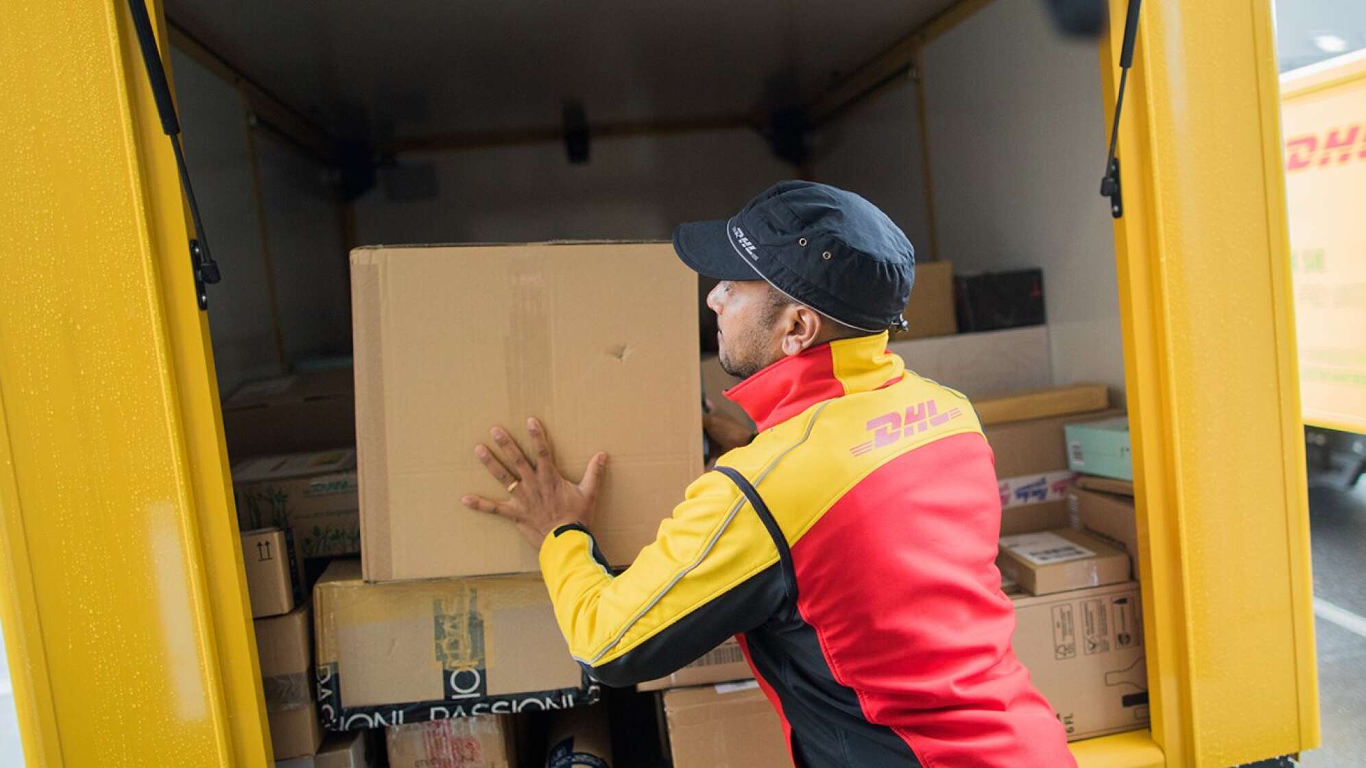 Eine Paketbote räumt Pakete ein