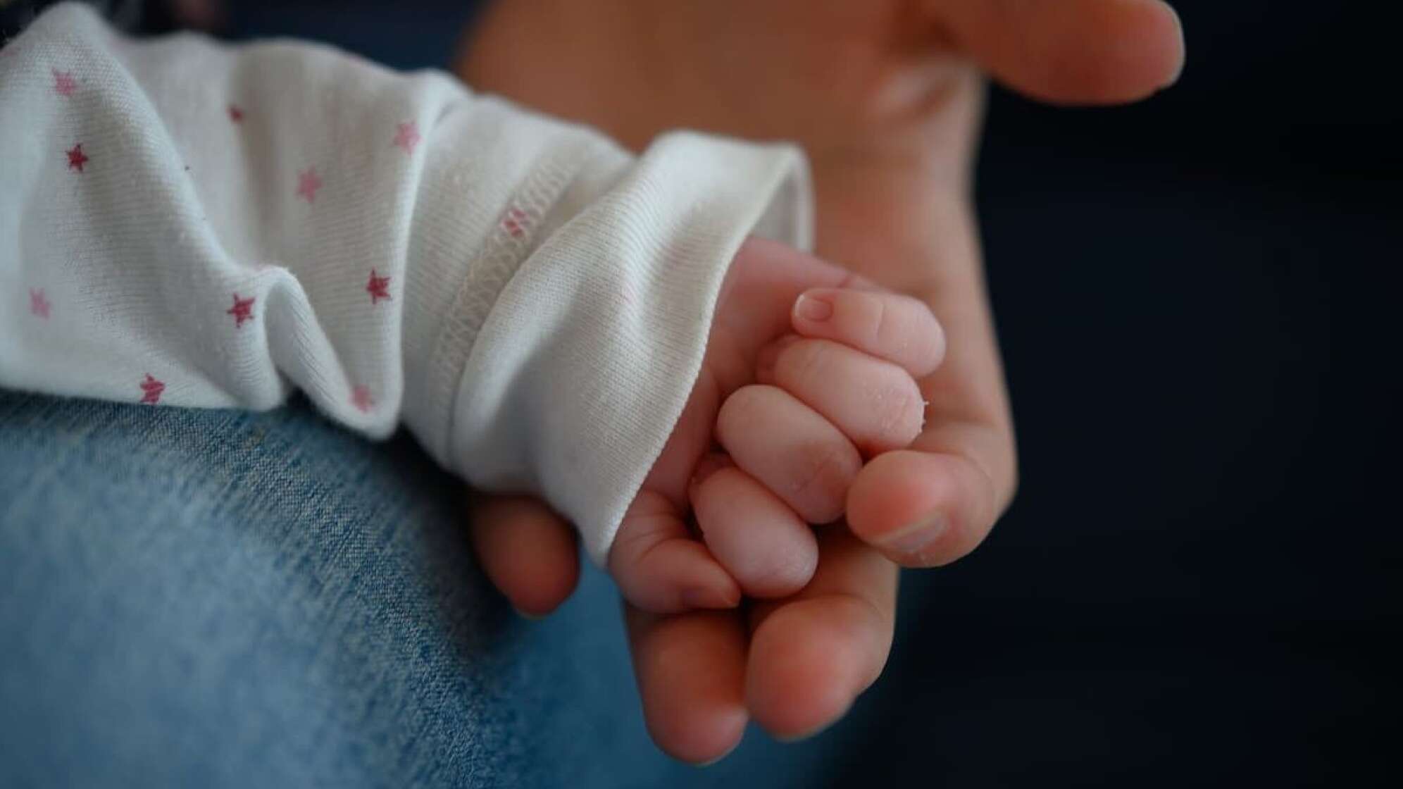 Die Hand eines Babys, die gehalten wird