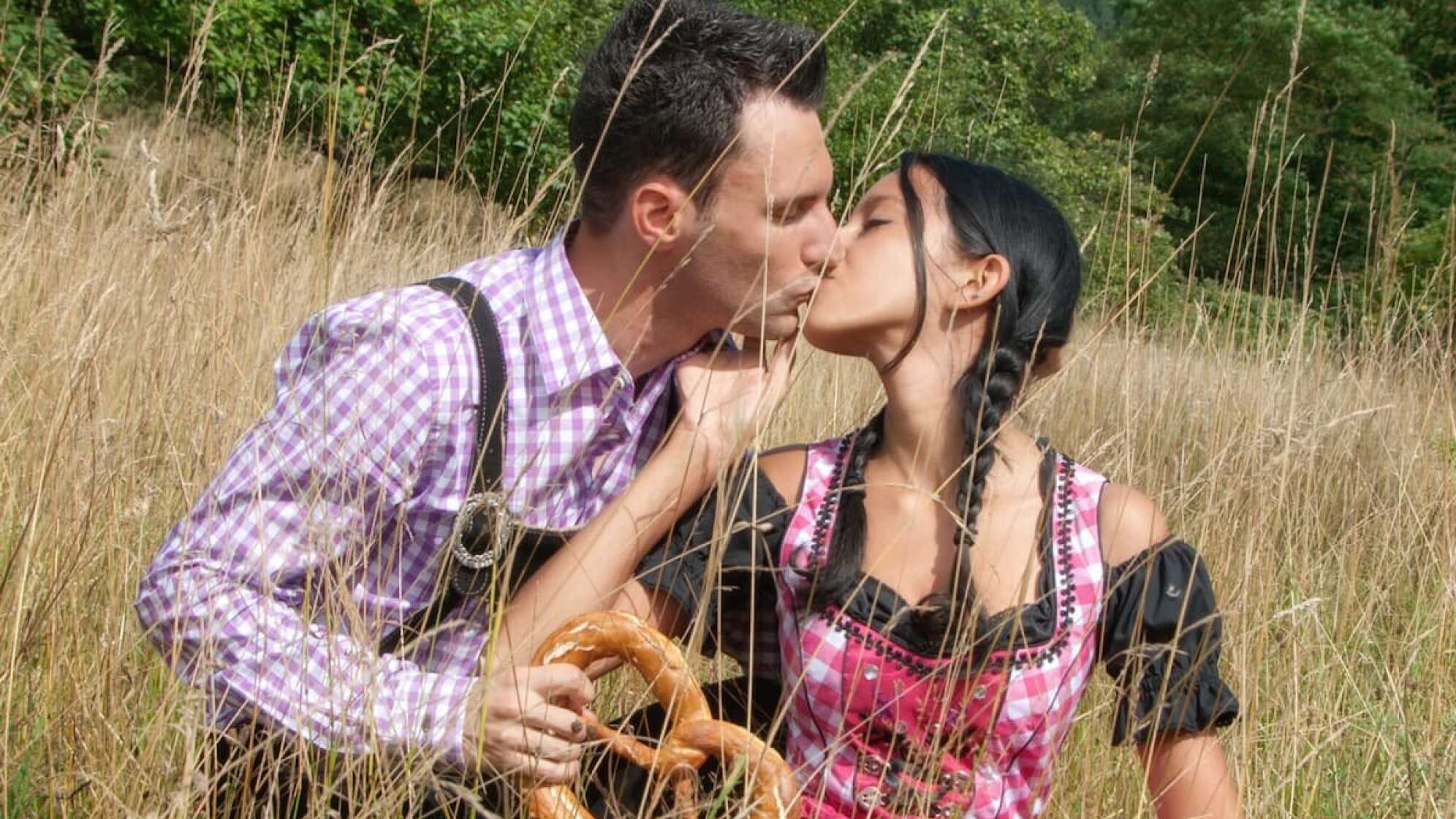 Eine Mann und eine Frau in Tracht, die sich küssen